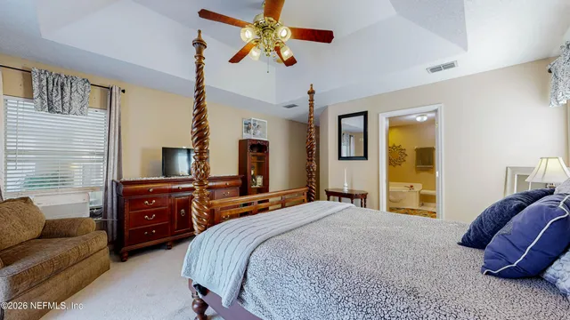 an aerial view of a house with a yard and lake view