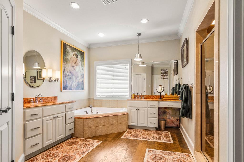 40 Enclave Court Waco, TX 76708 - Photo 15 of 40 a large spacious bathroom with a double vanity sink a mirror a bathtub and next to a window