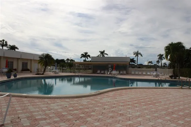 a view of a swimming pool with a yard