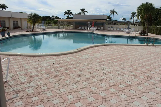 a view of a swimming pool with outdoor seating
