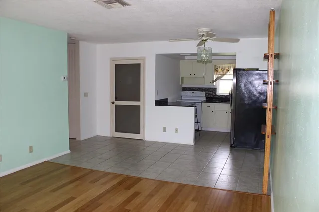 a kitchen with a refrigerator and a stove top oven