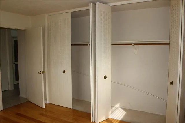 a view of a room with wooden floor