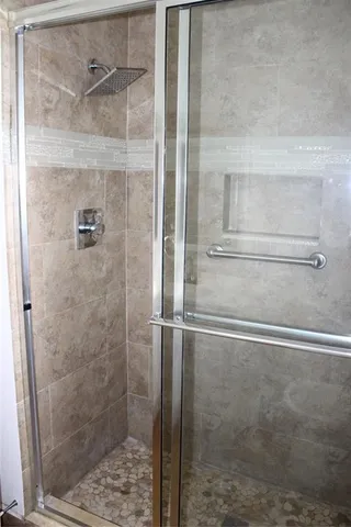 a bathroom with a glass shower door