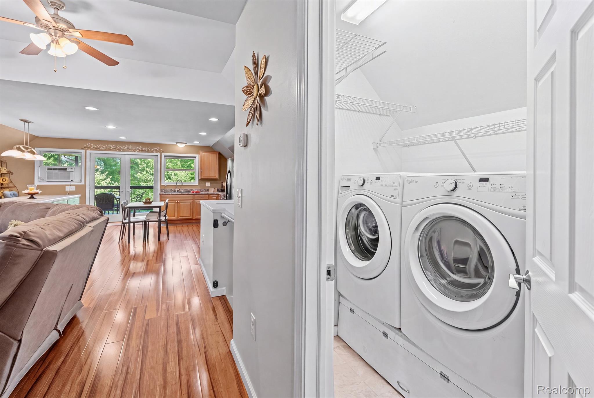 15055 South Duffield Road Byron, MI 48418 - Photo 15 of 61 Dedicated laundry closet featuring a stacked washer and dryer unit with wire shelving