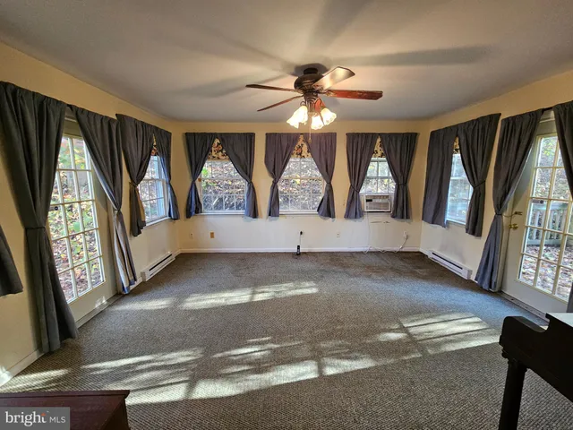 a view of an entryway with wooden floor and door