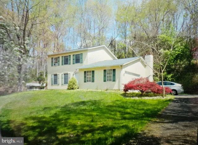 a front view of house with yard and trees