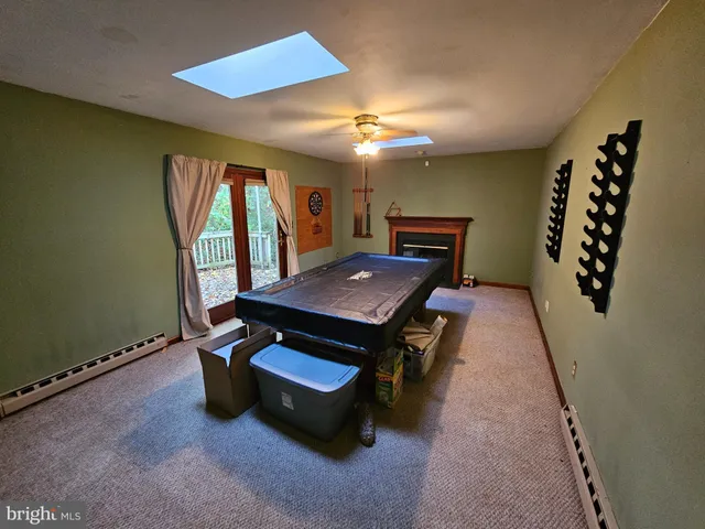 a living room with furniture pool table and furniture