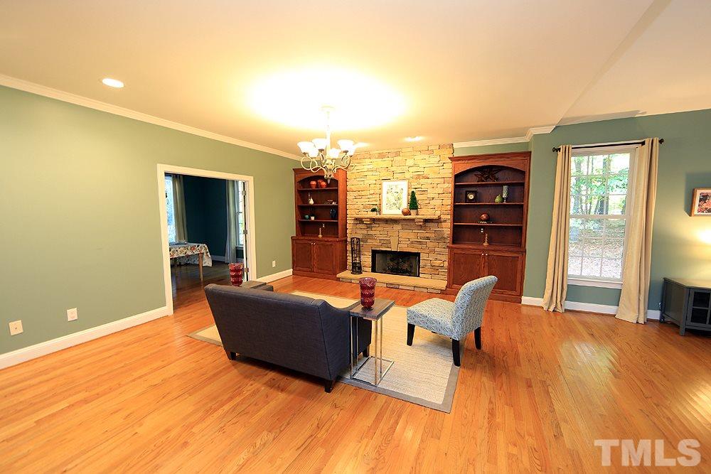 5921 Wild Orchid Trail Raleigh, NC 27613 - Photo 9 of 30 Beautiful built-ins flank the stacked stone fireplace.
