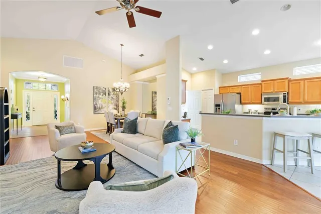a living room with furniture and a chandelier