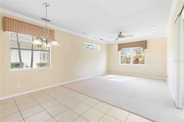 a view of a livingroom with furniture and a ceiling fan