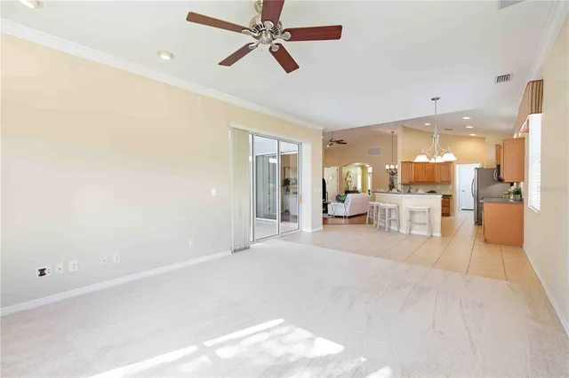 a bedroom with a bed a chandelier and a couch