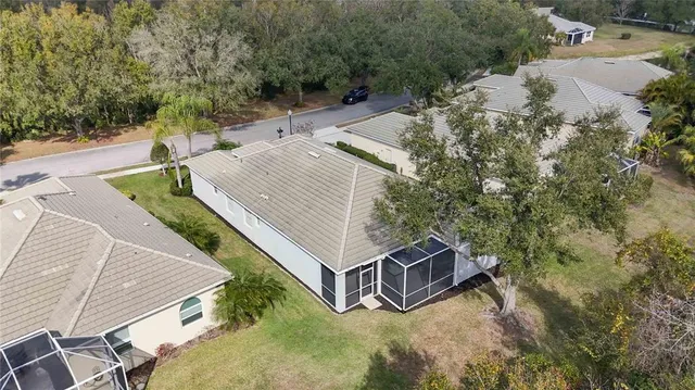 an aerial view of a house with a garden and swimming pool