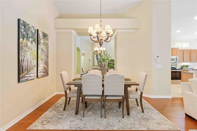 a view of a dining room with furniture wooden floor and chandelier