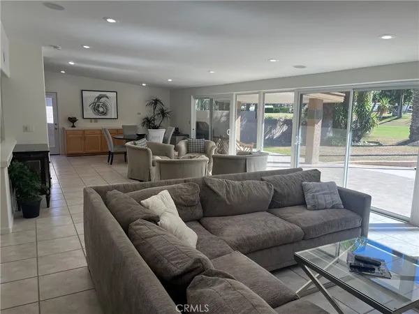 a living room with furniture and large window