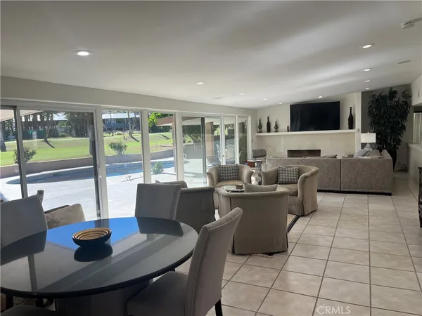 a living room with furniture and a floor to ceiling window