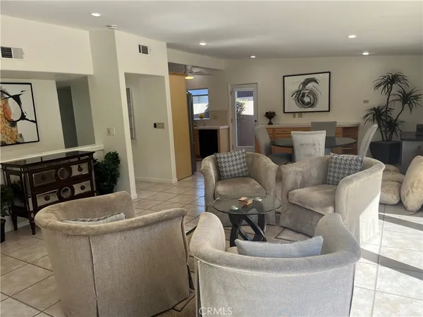a living room with fireplace furniture and a wooden floor