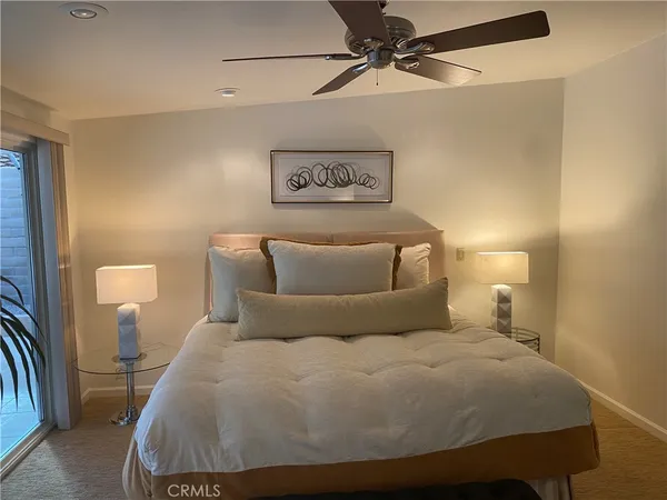 a bedroom with a bed and a lamp