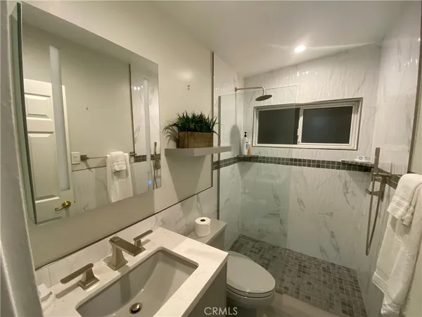 a view of a bathroom with a shower and a sink