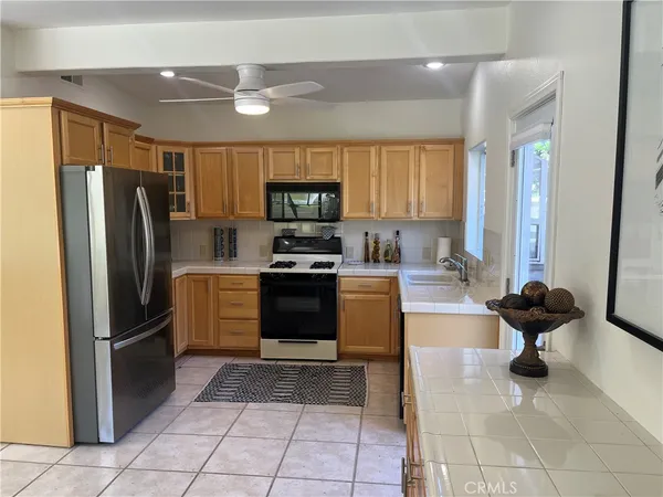a kitchen with stainless steel appliances granite countertop a refrigerator and a stove