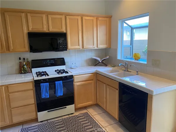 a kitchen with stainless steel appliances a stove a sink and a microwave