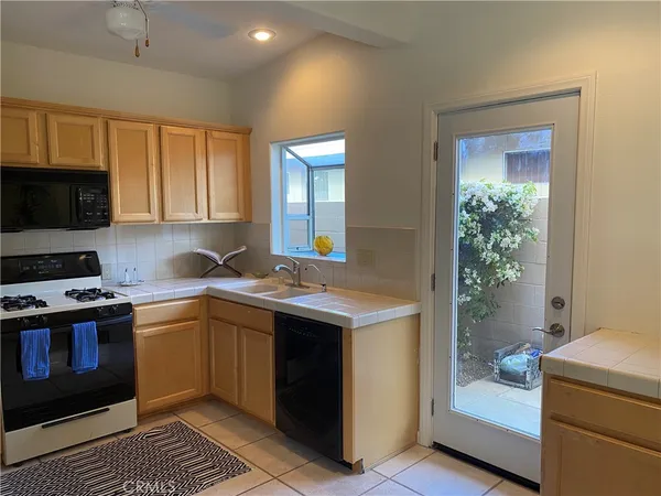 a kitchen with a sink and a stove top oven