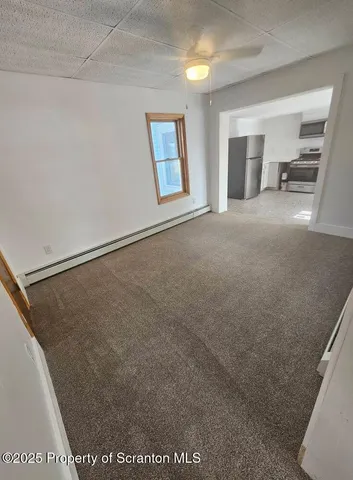 a view of a big room with closet and windows