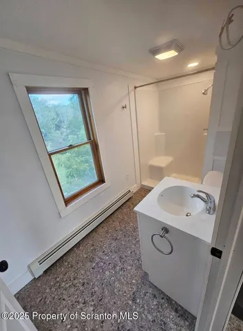 a bathroom with a sink a mirror and a shower