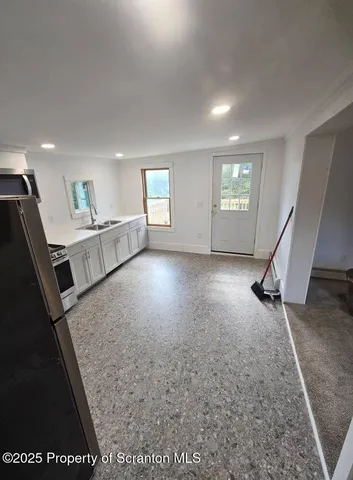 a view of a hallway with stairs