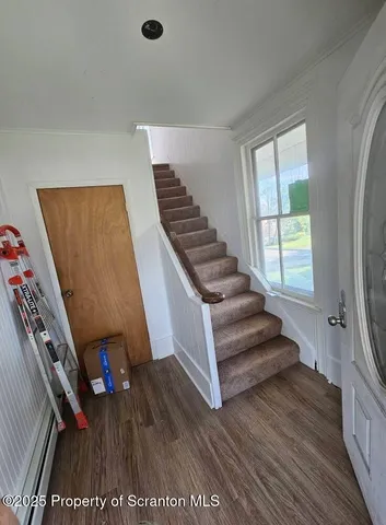 a view of an entryway with wooden floor