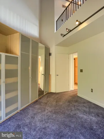 a view of closet area with wooden floor