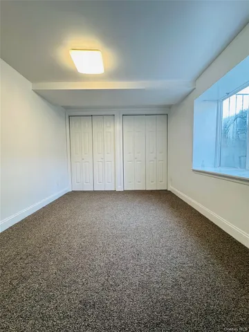 an empty room with a empty space and windows