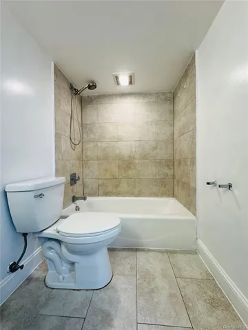 a bathroom with a bathtub and toilet