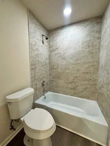 a bathroom with a toilet a sink and bathtub