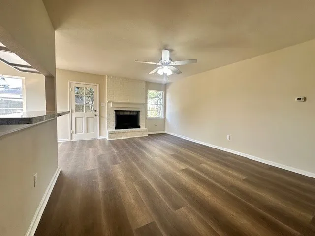 wooden floor in an empty room with a window