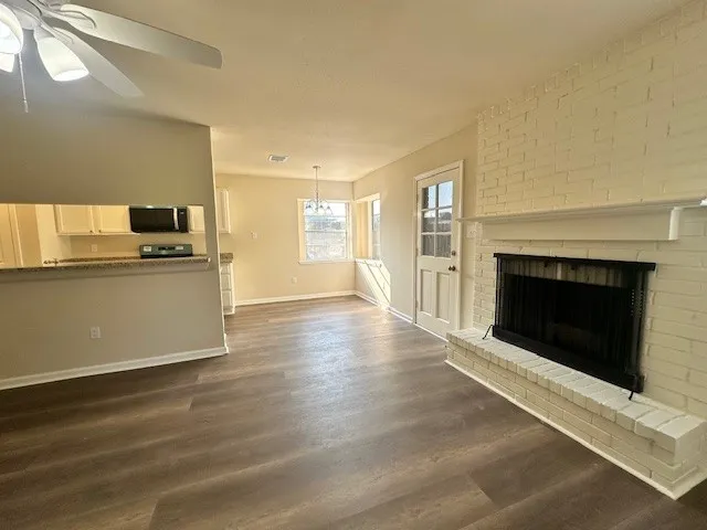 a view of a kitchen with a sink a refrigerator and a stove top oven