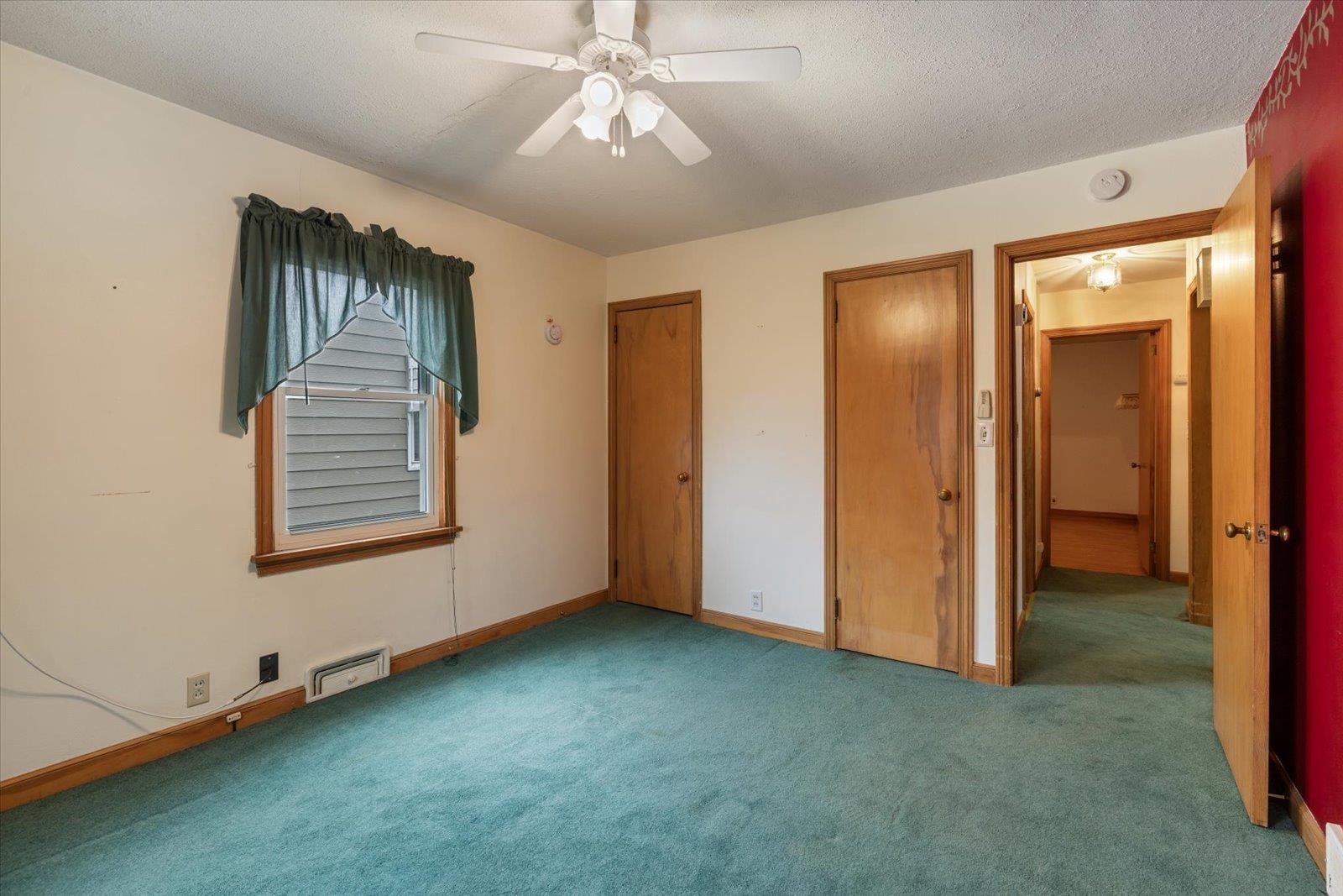 813 6th Street South Virginia, MN 55792 - Photo 23 of 44 Unfurnished bedroom with multiple closets, carpet floors, a textured ceiling, and ceiling fan