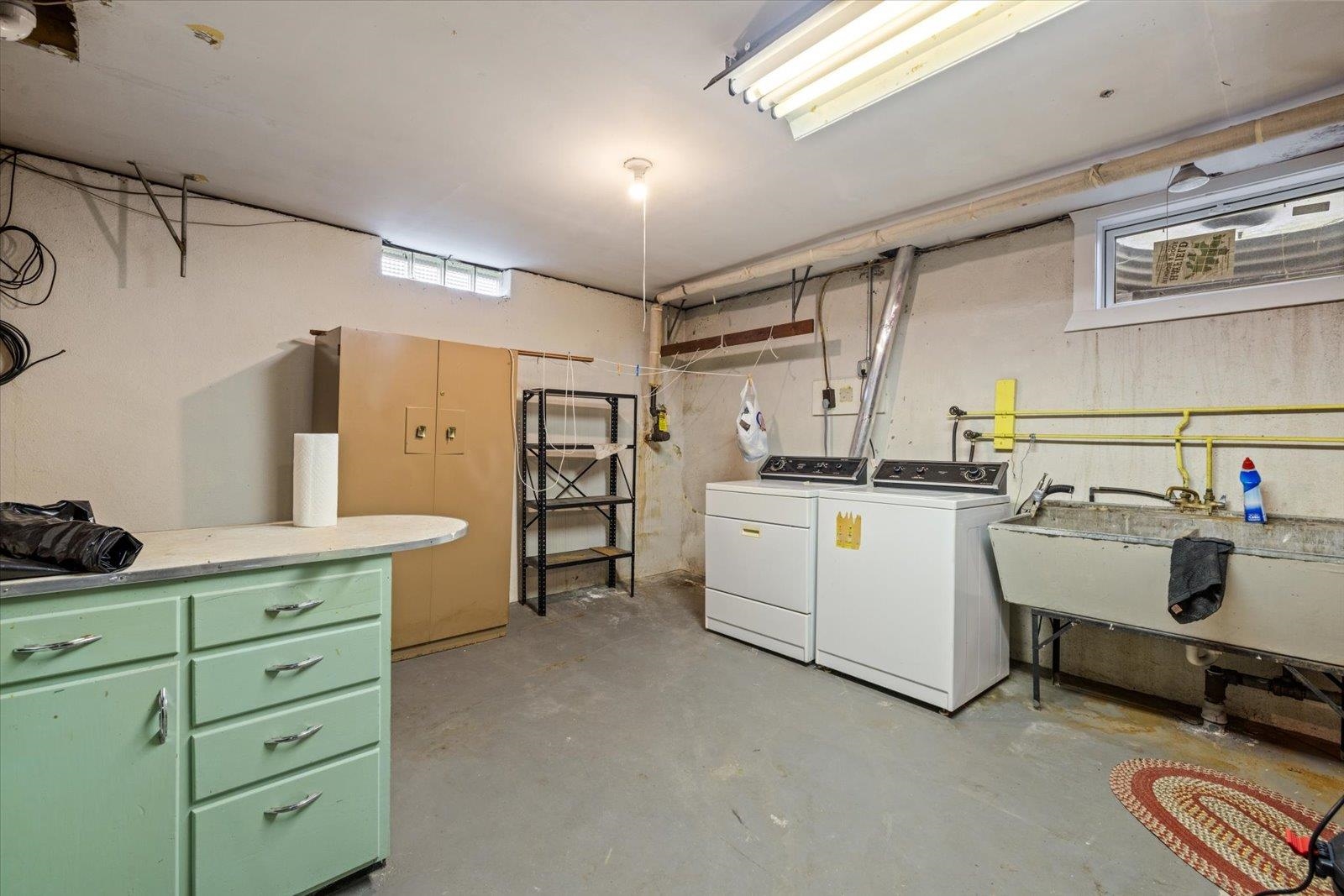 813 6th Street South Virginia, MN 55792 - Photo 36 of 44 Laundry room featuring unfinished concrete flooring and separate washer and dryer
