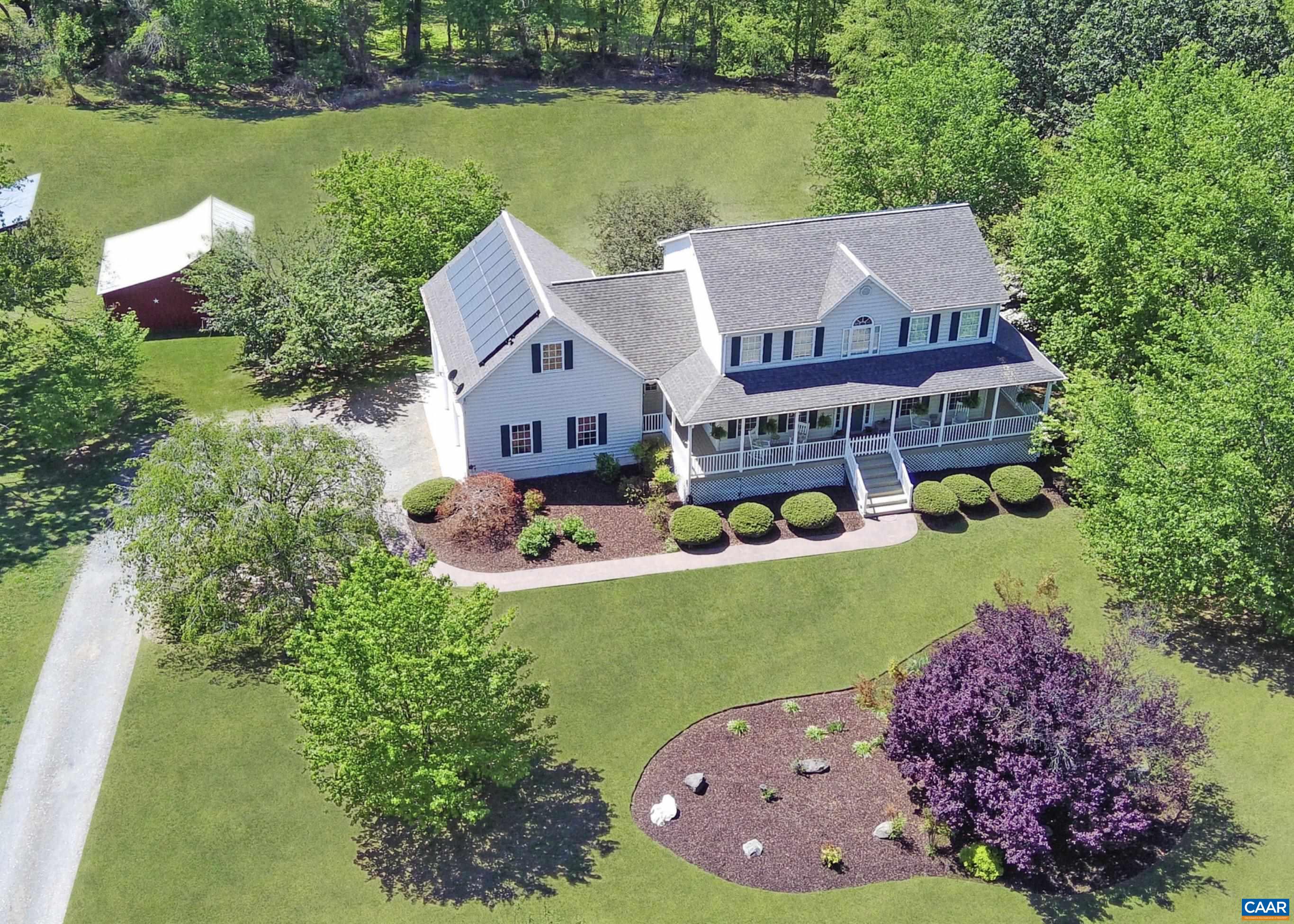 an aerial view of a house with swimming pool a yard and outdoor seating
