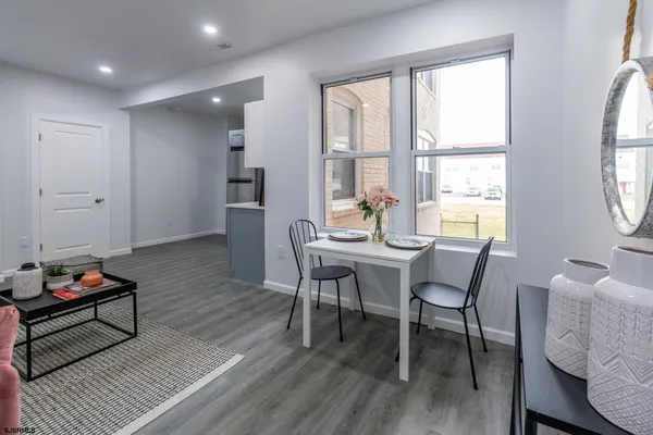 a dining room with furniture and wooden floor