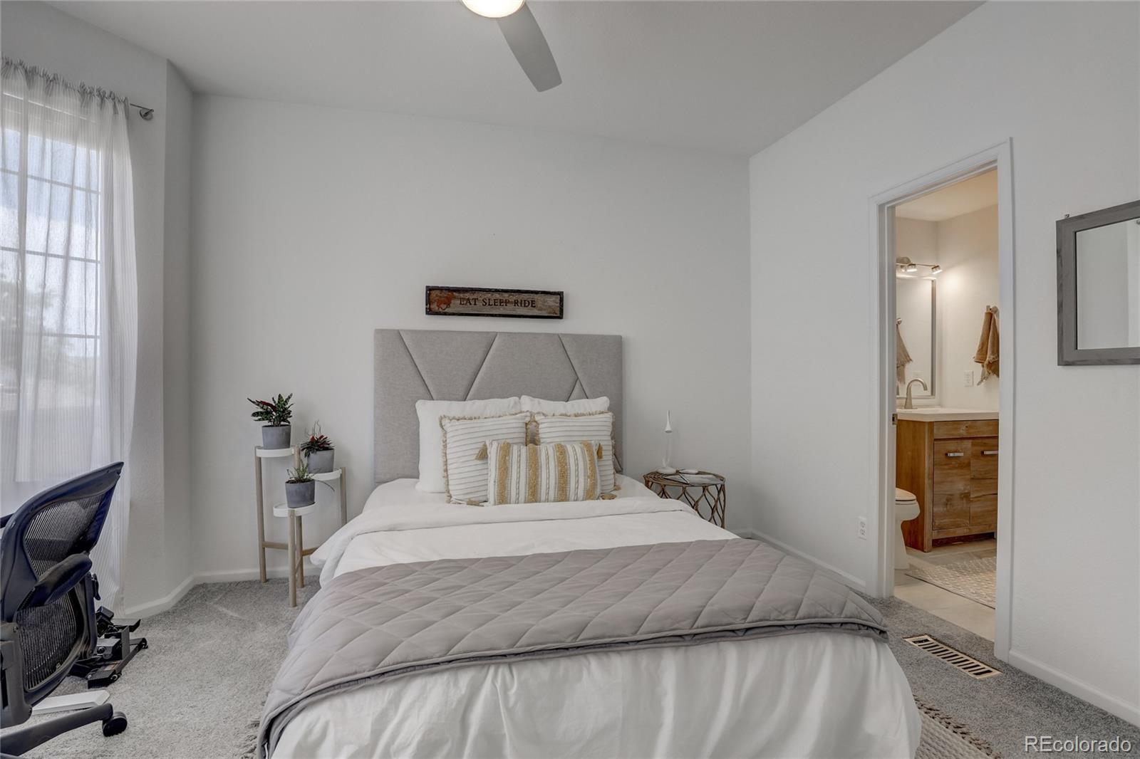 6120 Trailhead Road Highlands Ranch, CO 80130 - Photo 11 of 29 a bedroom with a bed and a chair