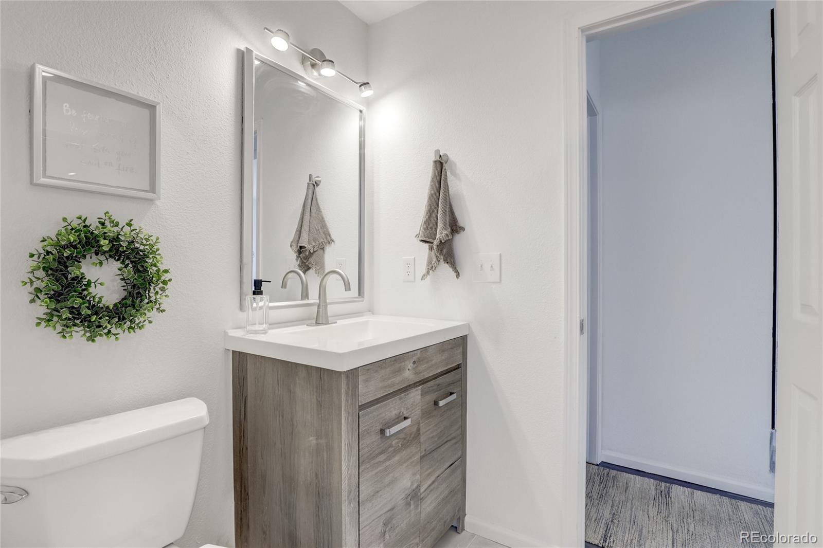6120 Trailhead Road Highlands Ranch, CO 80130 - Photo 12 of 29 a bathroom with a sink toilet and vanity