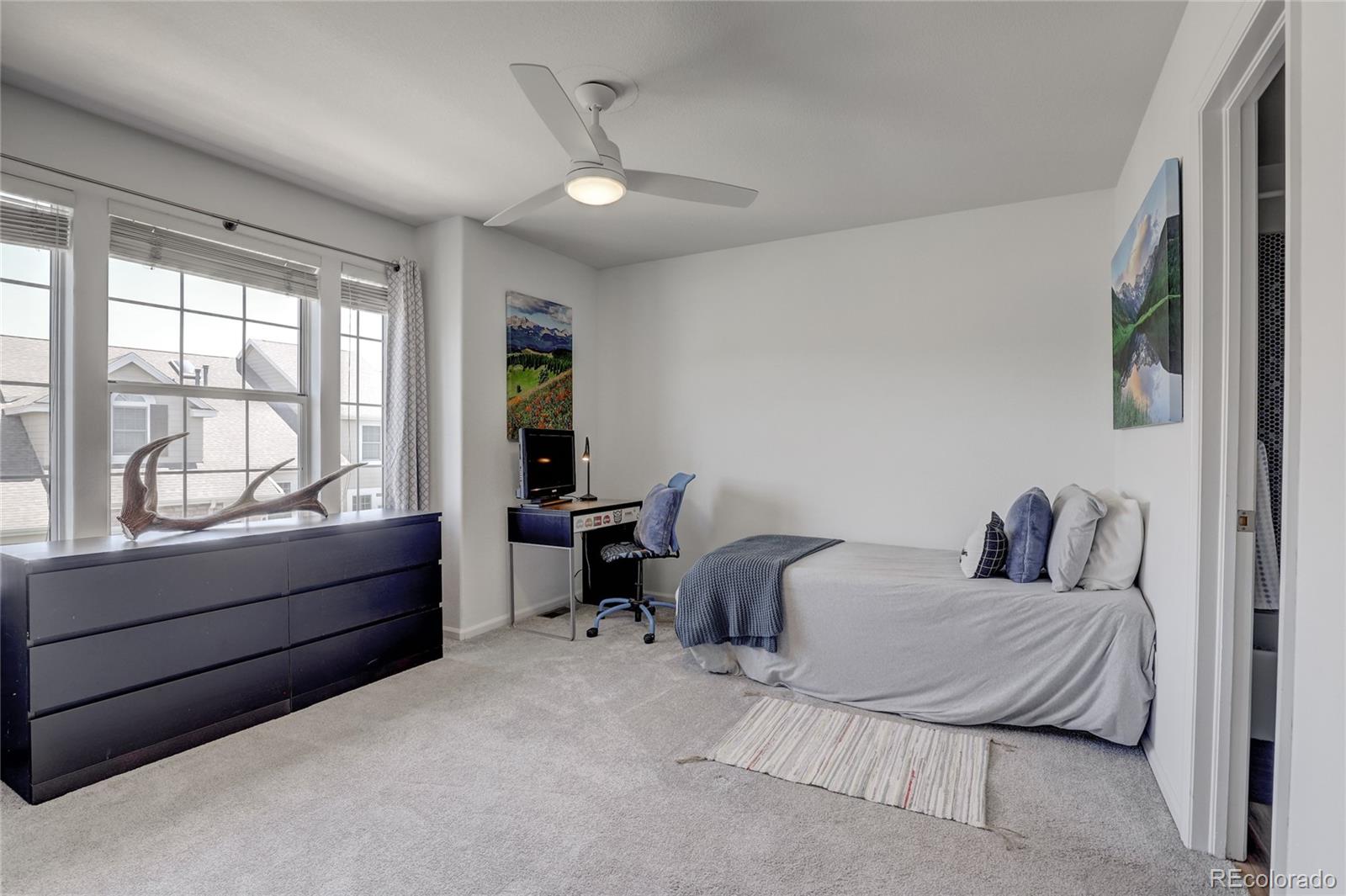 6120 Trailhead Road Highlands Ranch, CO 80130 - Photo 17 of 29 a bedroom with a bed and a large window