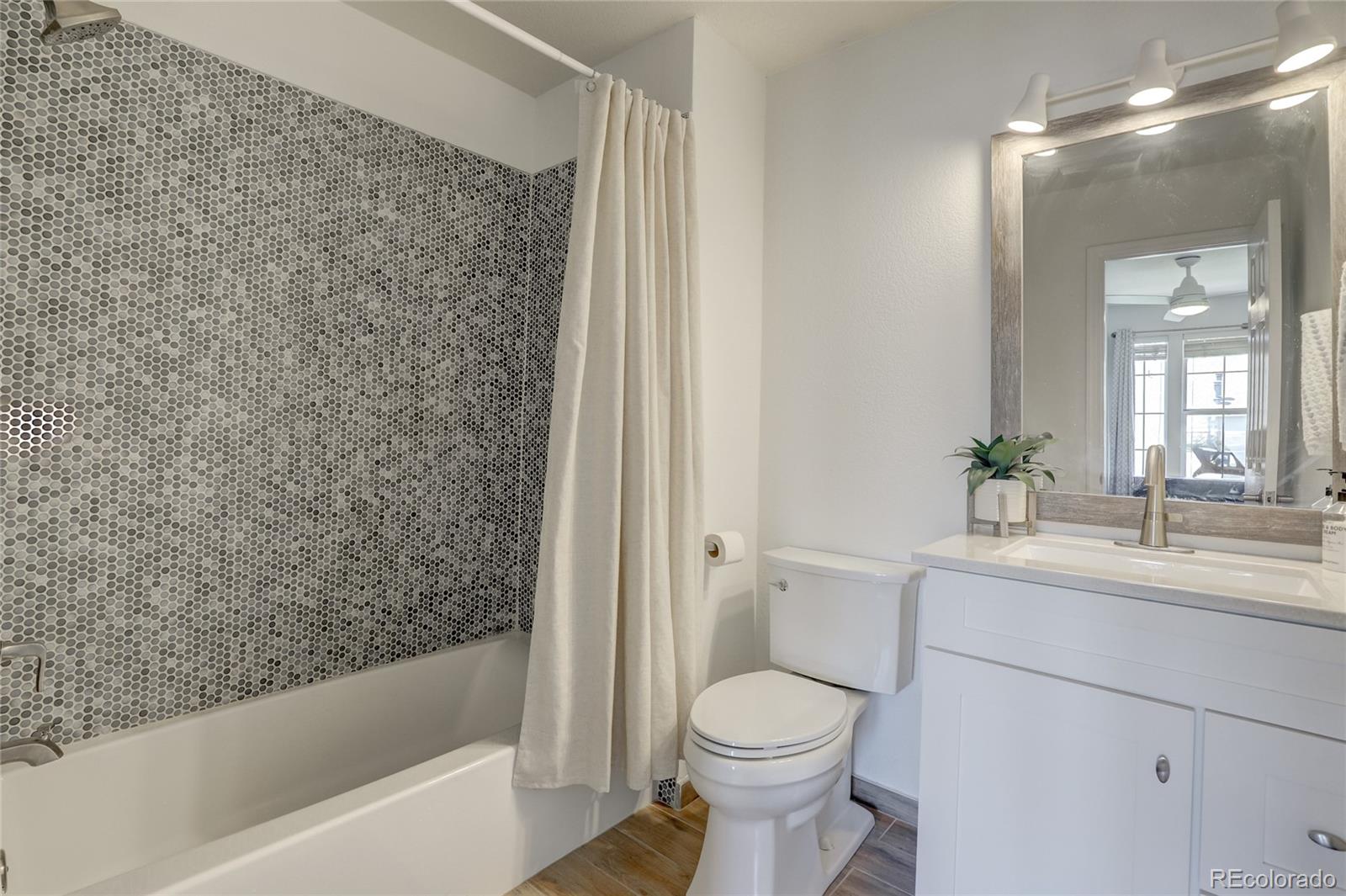 6120 Trailhead Road Highlands Ranch, CO 80130 - Photo 18 of 29 a bathroom with a sink a toilet and shower