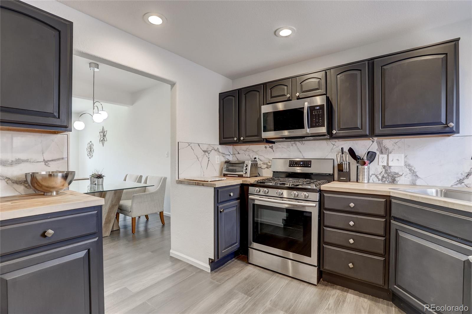 6120 Trailhead Road Highlands Ranch, CO 80130 - Photo 9 of 29 a kitchen with a stove and a microwave oven