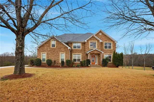 a front view of a house with a yard