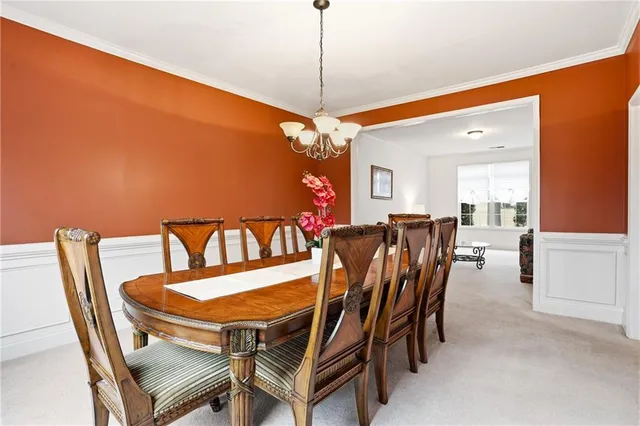 a kitchen with a stove a sink wooden floor and a window
