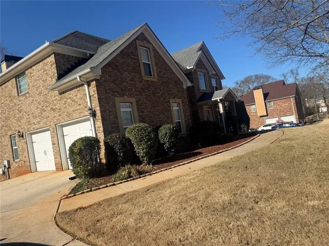 a front view of a house with parking space