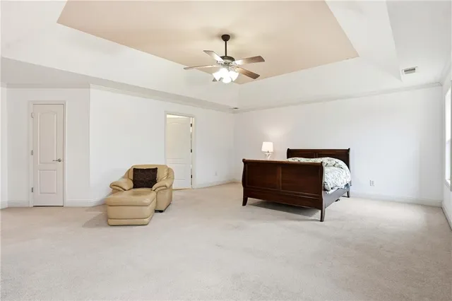 a front view of house with yard and trees in the background