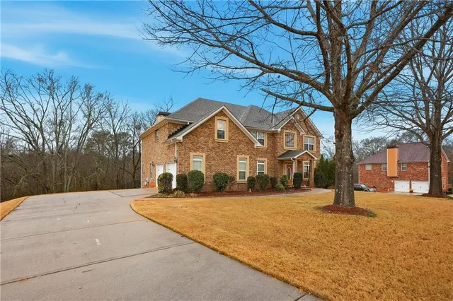a spacious bathroom with a tub sink and mirror