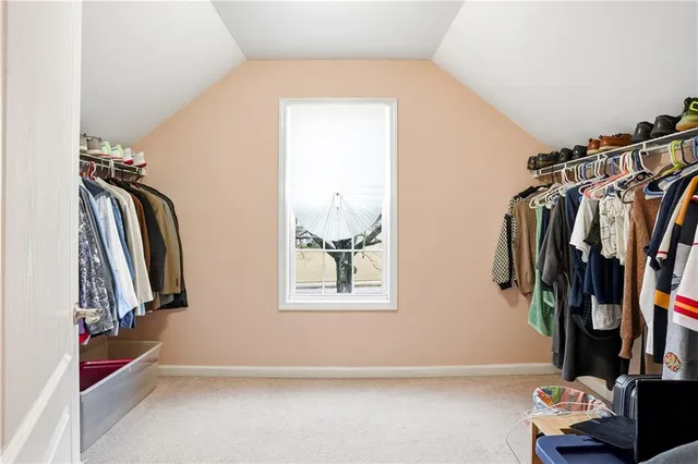 a bathroom with a granite countertop toilet a sink and a mirror